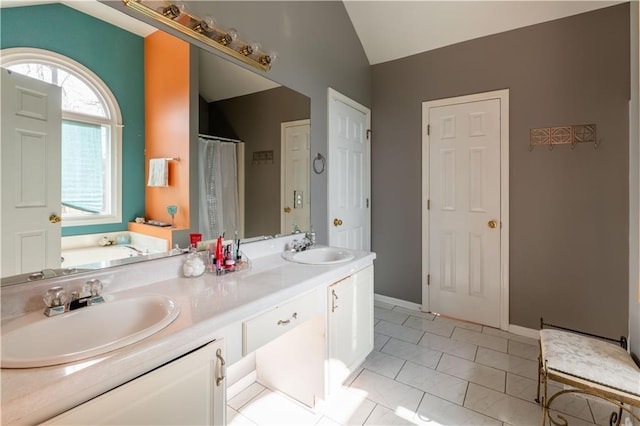 bathroom featuring lofted ceiling, vanity, and a bathtub