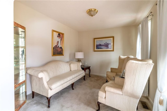 living area featuring light carpet