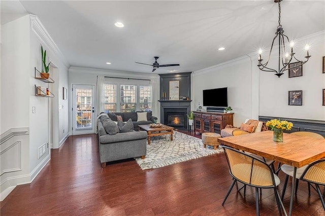 1012 E Paces Chase, Atlanta, GA 30326 - living area with ornamental molding, a ceiling fan, dark wood-style flooring, a glass covered fireplace, and a chandelier