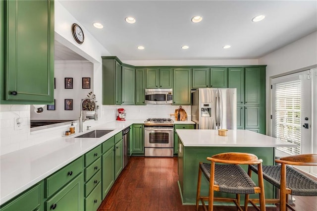 1012 E Paces Chase, Atlanta, GA 30326 - kitchen featuring stainless steel appliances, a sink, a breakfast bar, decorative backsplash, and recessed lighting