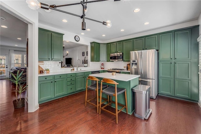 1012 E Paces Chase, Atlanta, GA 30326 - kitchen featuring appliances with stainless steel finishes, light countertops, backsplash, green cabinetry, and recessed lighting