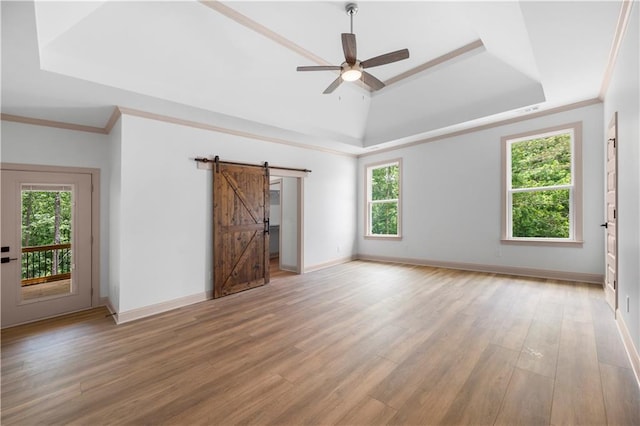 4786 Conns Creek Rd, Ball Ground, GA 30107 - unfurnished room with a raised ceiling, a barn door, healthy amount of natural light, light wood-style floors, and ornamental molding