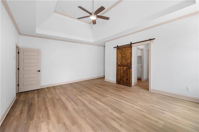 4786 Conns Creek Rd, Ball Ground, GA 30107 - unfurnished room with a ceiling fan, a raised ceiling, a barn door, light wood-style floors, and crown molding