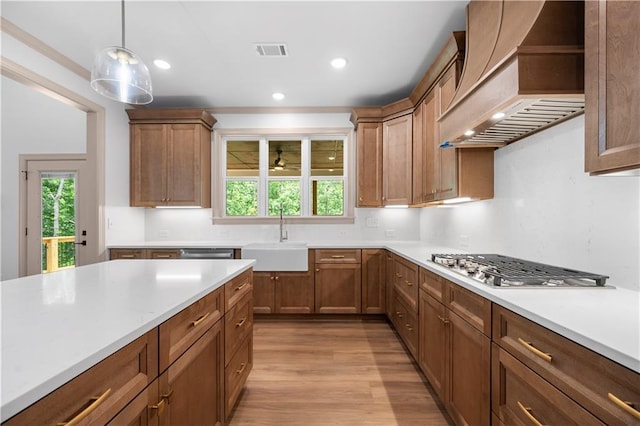 4786 Conns Creek Rd, Ball Ground, GA 30107 - kitchen featuring premium range hood, appliances with stainless steel finishes, light wood-style flooring, light countertops, and hanging light fixtures