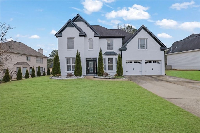 view of front of property featuring a garage and a front lawn