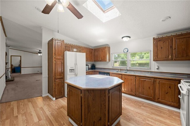 kitchen with white appliances, ceiling fan, light wood-style floors, and vaulted ceiling