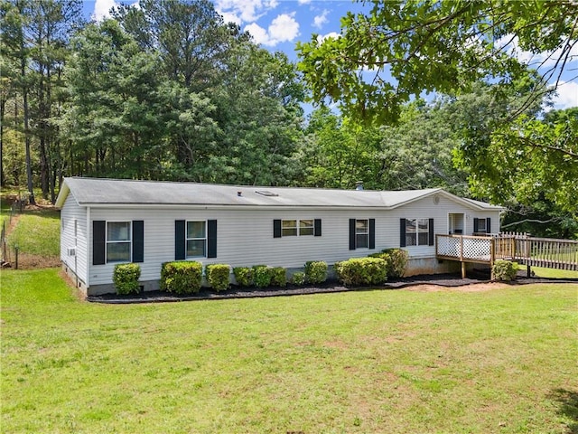 manufactured / mobile home with crawl space, a front yard, and a wooden deck