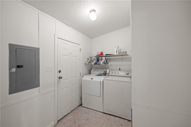 clothes washing area with electric panel, independent washer and dryer, and a textured ceiling