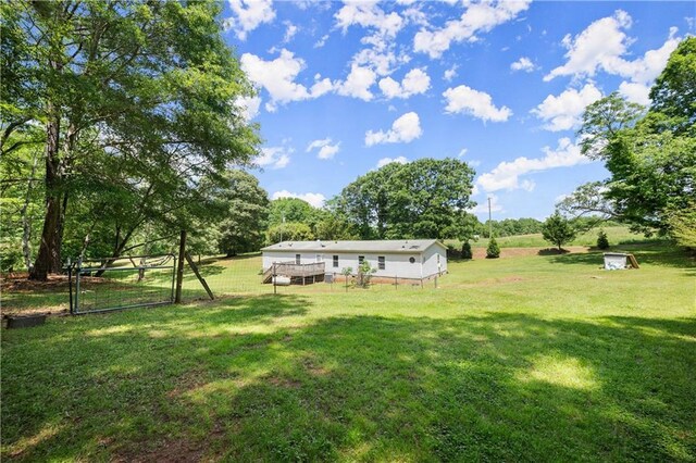 view of yard featuring a gate and a wooden deck