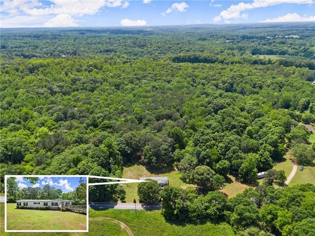 view of property location featuring a heavily wooded area and property parcel outlined