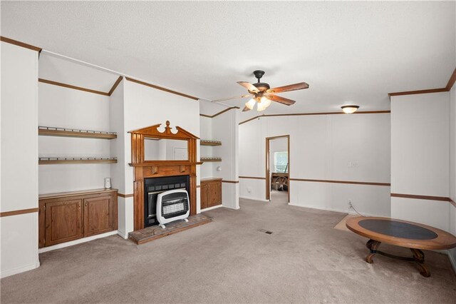 carpeted living room with a ceiling fan, crown molding, and a textured ceiling