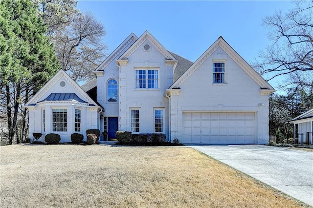 view of front of house with a front yard, concrete driveway, brick siding, and an attached garage