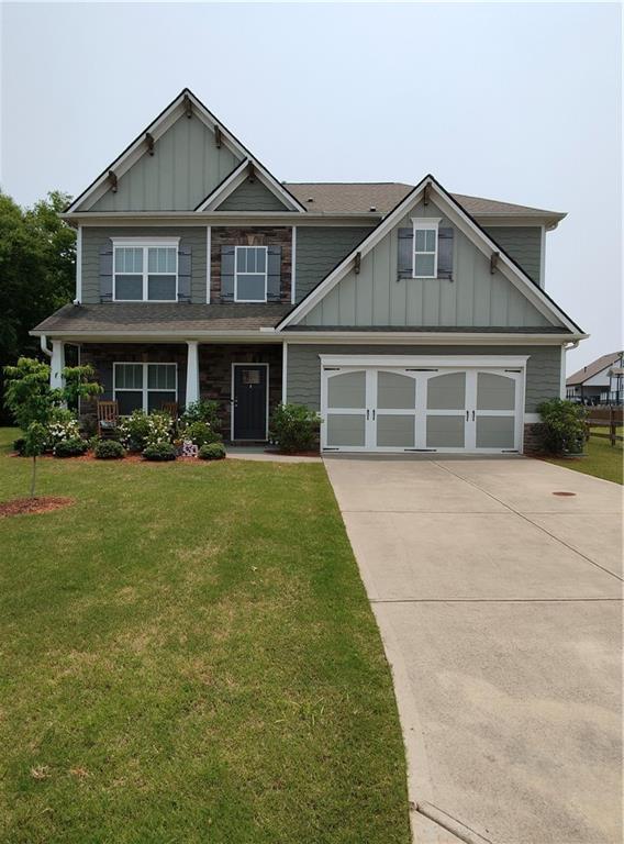 13 Mulberry Way, Cartersville, GA 30120 - craftsman-style home with driveway, board and batten siding, a front yard, and a garage