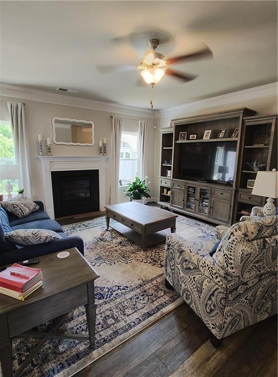 13 Mulberry Way, Cartersville, GA 30120 - living area with wood finished floors, crown molding, a ceiling fan, and a fireplace