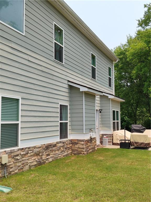 13 Mulberry Way, Cartersville, GA 30120 - rear view of house featuring a yard, an outdoor living space, and stone siding