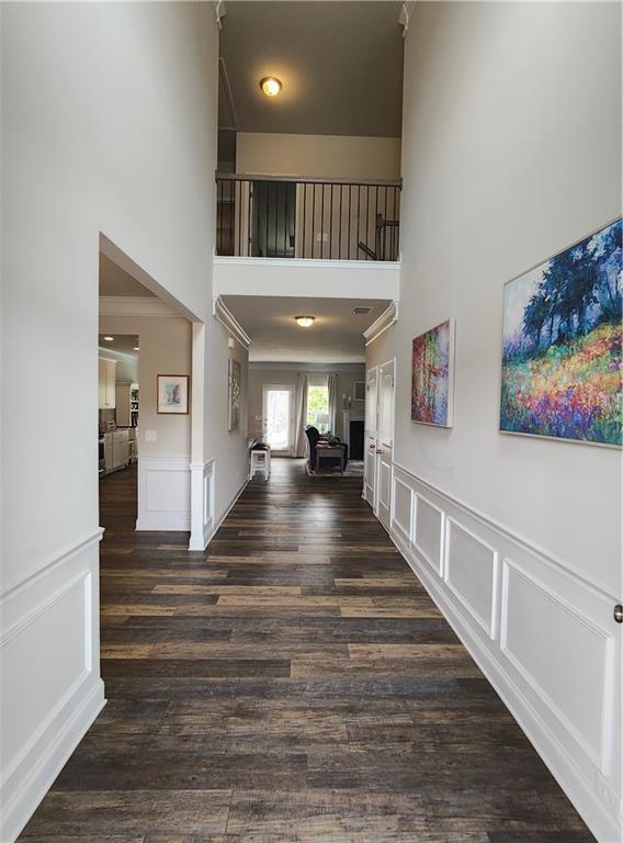 13 Mulberry Way, Cartersville, GA 30120 - entryway with a high ceiling, a decorative wall, wood finished floors, crown molding, and wainscoting