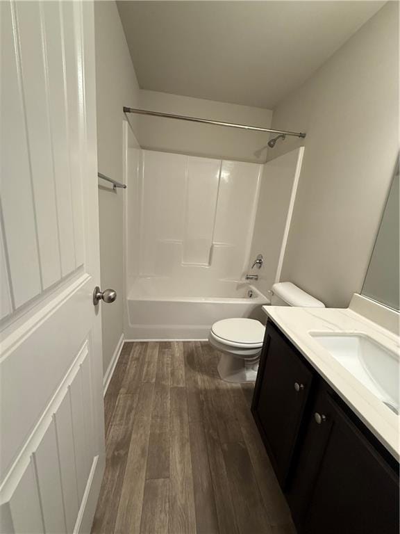 full bathroom featuring vanity, hardwood / wood-style flooring, bathing tub / shower combination, and toilet