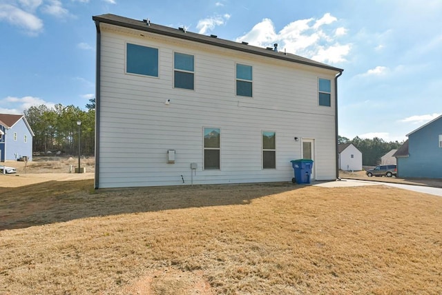 rear view of property with a yard