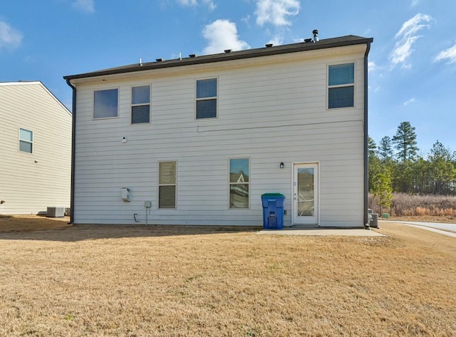 back of property with cooling unit, a lawn, and a patio