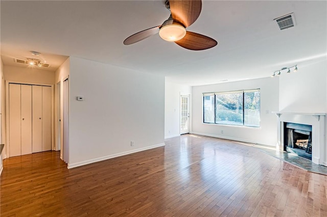 unfurnished living room featuring hardwood / wood-style floors and ceiling fan