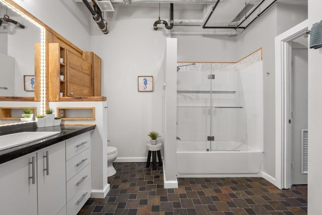 full bathroom featuring vanity, shower / bath combination with glass door, and toilet