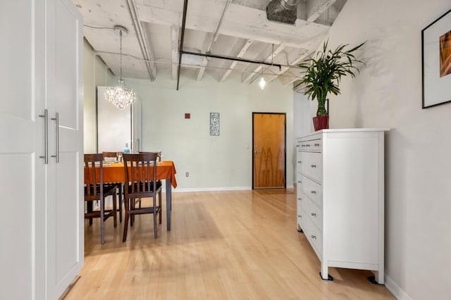 dining area with a chandelier and light hardwood / wood-style flooring