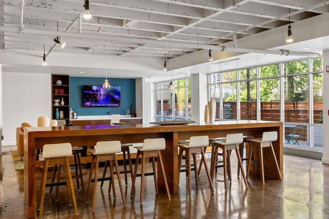 bar with plenty of natural light and concrete floors