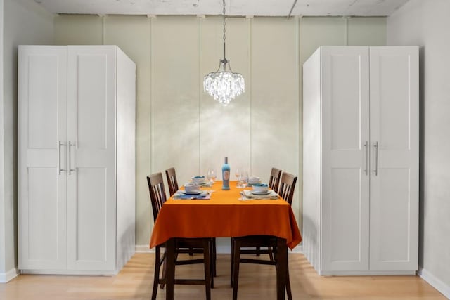 dining space featuring a notable chandelier and light hardwood / wood-style floors