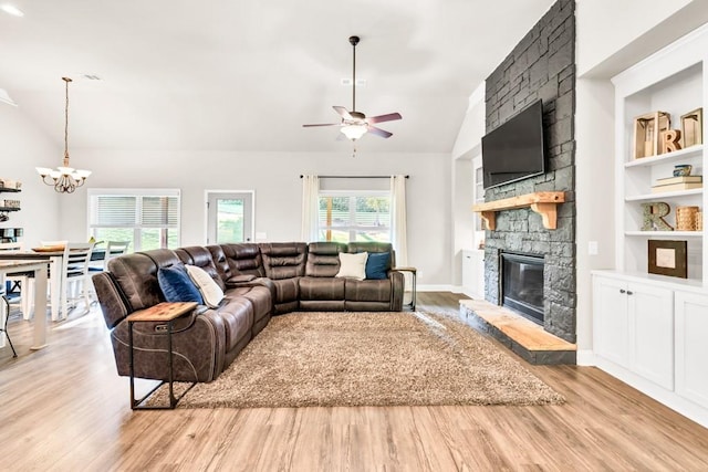 2980 Beards Rd, Buford, GA 30518 - living area with a chandelier, vaulted ceiling, light wood-type flooring, a fireplace, and a ceiling fan