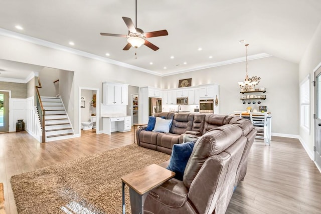2980 Beards Rd, Buford, GA 30518 - living room with stairs, a chandelier, a ceiling fan, baseboards, and light wood finished floors