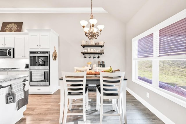 2980 Beards Rd, Buford, GA 30518 - dining room featuring a chandelier, light wood-type flooring, lofted ceiling, baseboards, and ornamental molding