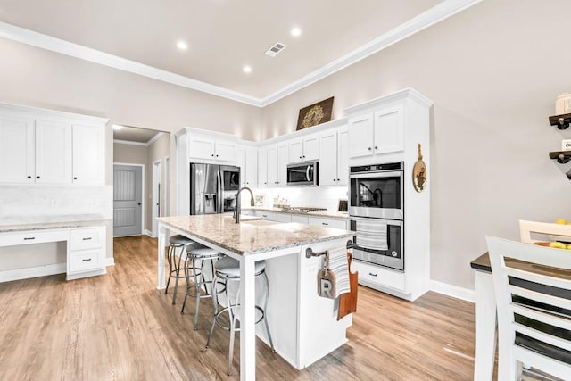 2980 Beards Rd, Buford, GA 30518 - kitchen with stainless steel appliances, a sink, crown molding, a kitchen bar, and decorative backsplash