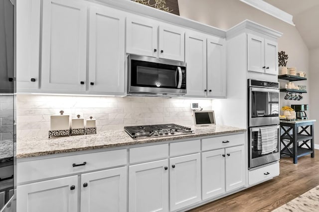 2980 Beards Rd, Buford, GA 30518 - kitchen featuring stainless steel appliances, white cabinetry, crown molding, wood finished floors, and decorative backsplash
