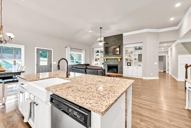 2980 Beards Rd, Buford, GA 30518 - kitchen with stainless steel dishwasher, ceiling fan, a stone fireplace, a sink, and a chandelier