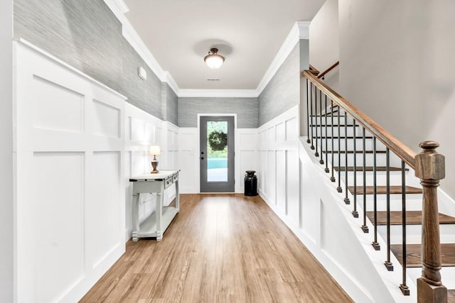 2980 Beards Rd, Buford, GA 30518 - entryway with a decorative wall, ornamental molding, light wood-type flooring, a wainscoted wall, and stairway