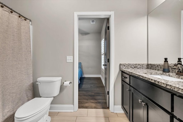 2980 Beards Rd, Buford, GA 30518 - full bathroom featuring toilet, vanity, baseboards, and tile patterned flooring