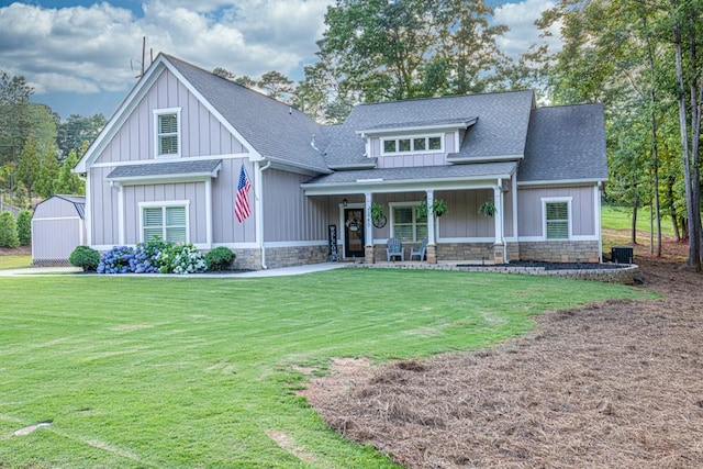2980 Beards Rd, Buford, GA 30518 - craftsman-style home with roof with shingles, a front yard, covered porch, and stone siding