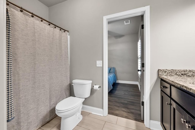 2980 Beards Rd, Buford, GA 30518 - ensuite bathroom with toilet, vanity, tile patterned flooring, and baseboards