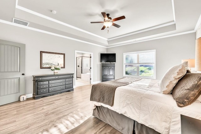 2980 Beards Rd, Buford, GA 30518 - bedroom featuring a tray ceiling, wood finished floors, baseboards, ornamental molding, and ensuite bath