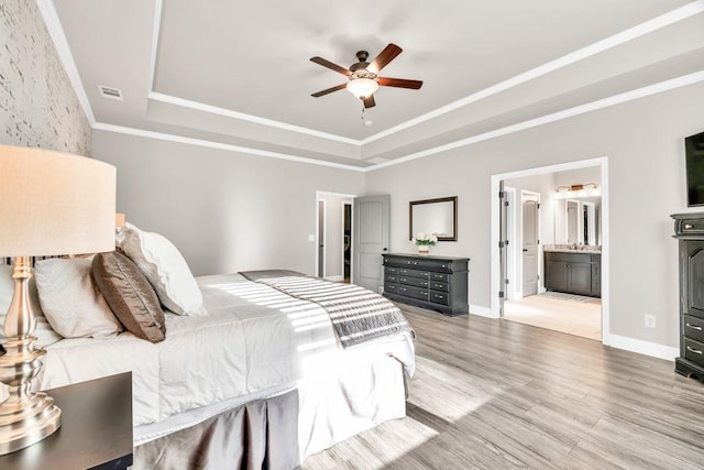 2980 Beards Rd, Buford, GA 30518 - bedroom with a tray ceiling, wood finished floors, baseboards, a ceiling fan, and ensuite bathroom