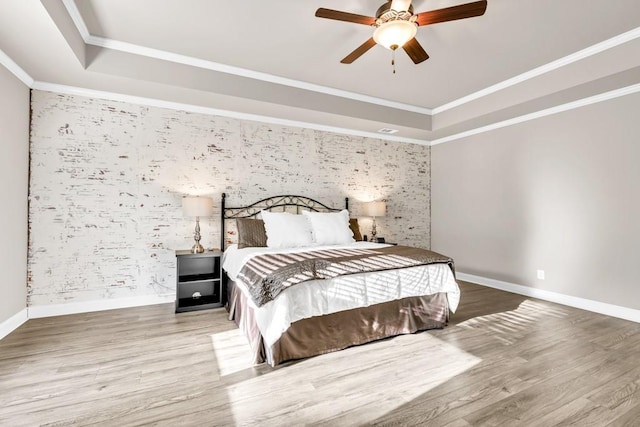 2980 Beards Rd, Buford, GA 30518 - bedroom featuring an accent wall, a tray ceiling, wood finished floors, baseboards, and wallpapered walls