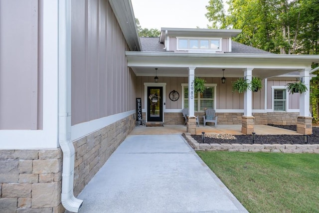 2980 Beards Rd, Buford, GA 30518 - view of exterior entry with stone siding, covered porch, a shingled roof, and board and batten siding