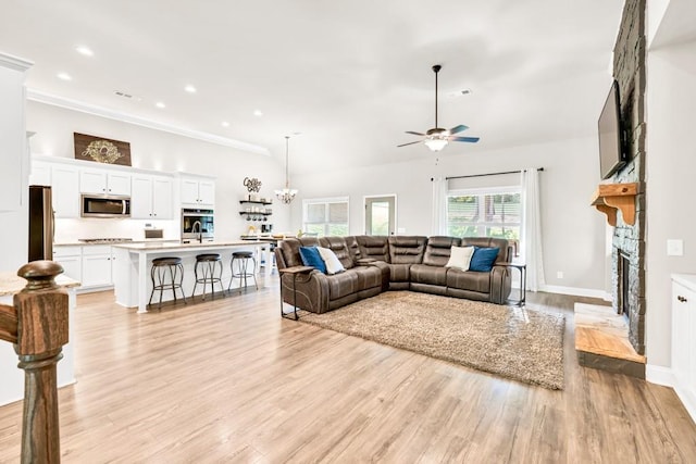 2980 Beards Rd, Buford, GA 30518 - living room featuring ceiling fan, a fireplace, light wood-style floors, recessed lighting, and crown molding