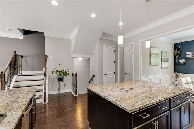 kitchen with ornamental molding, recessed lighting, light stone counters, dark wood finished floors, and hanging light fixtures