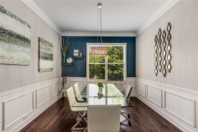 dining space featuring ornamental molding, dark wood-style flooring, a decorative wall, and wainscoting