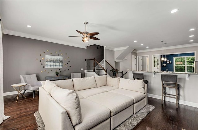 living room featuring crown molding, recessed lighting, and baseboards