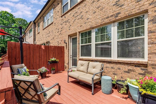 deck featuring an outdoor hangout area and fence