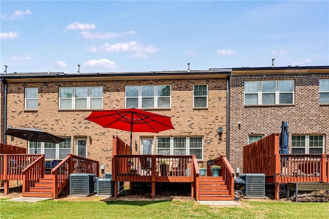 back of property featuring brick siding, central air condition unit, and a wooden deck