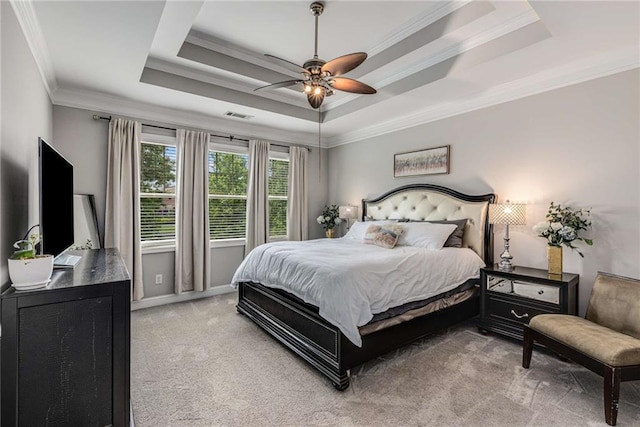 bedroom featuring ceiling fan, visible vents, crown molding, light colored carpet, and a raised ceiling
