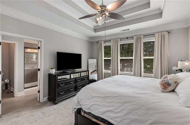 bedroom featuring a ceiling fan, visible vents, light colored carpet, a raised ceiling, and ornamental molding
